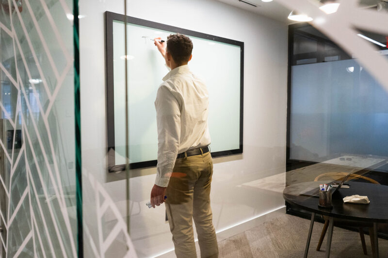 Marketing consultant mapping out a growth strategy in the We Marketing Co office